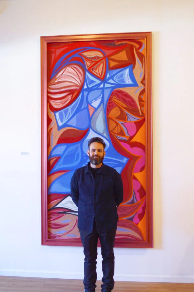 Ian with painting at gallery